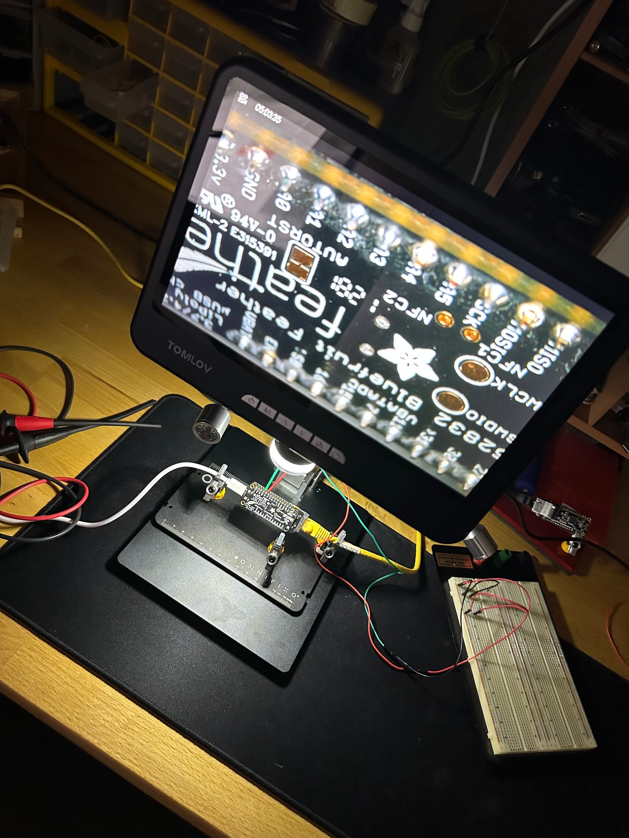 Monitor, microcontroller, and breadboard arranged for an early networked tally-light bench test
