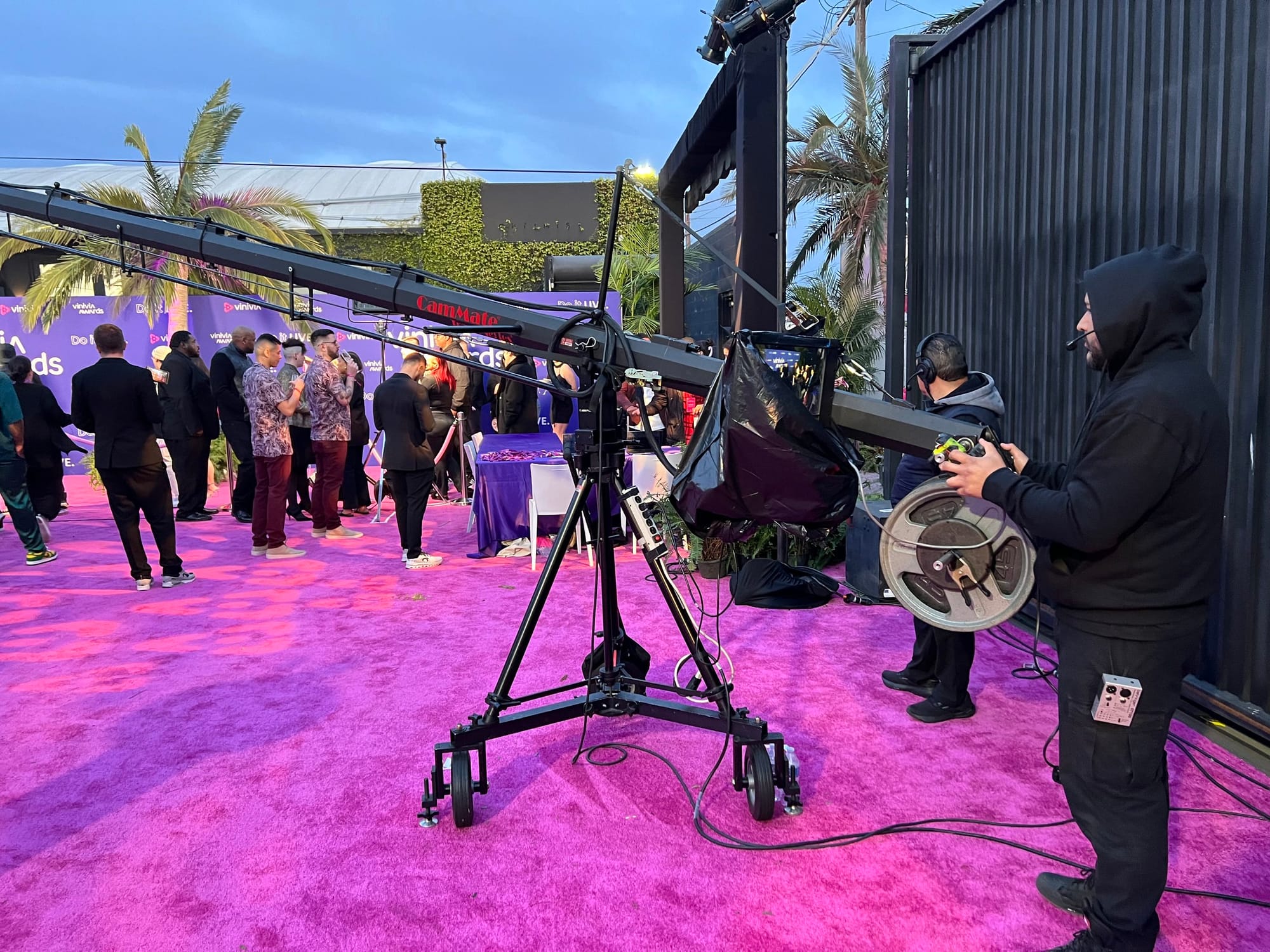 Camera operator and production equipment beside the outdoor event area