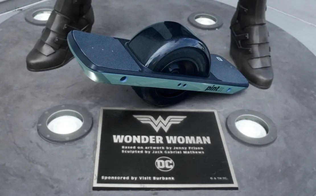 Original Onewheel Pint X beside the public Wonder Woman statue in Burbank