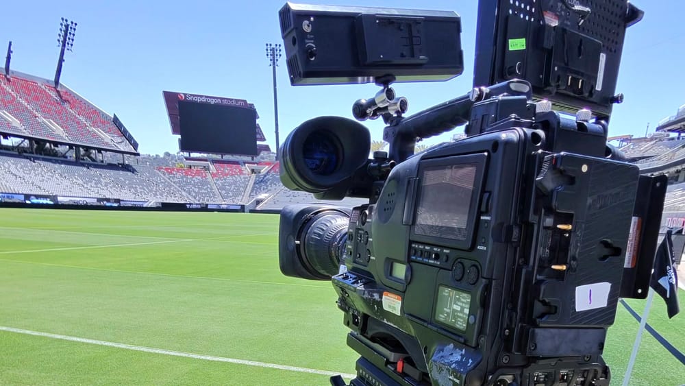 Broadcast camera prepared beside the pitch at Snapdragon Stadium